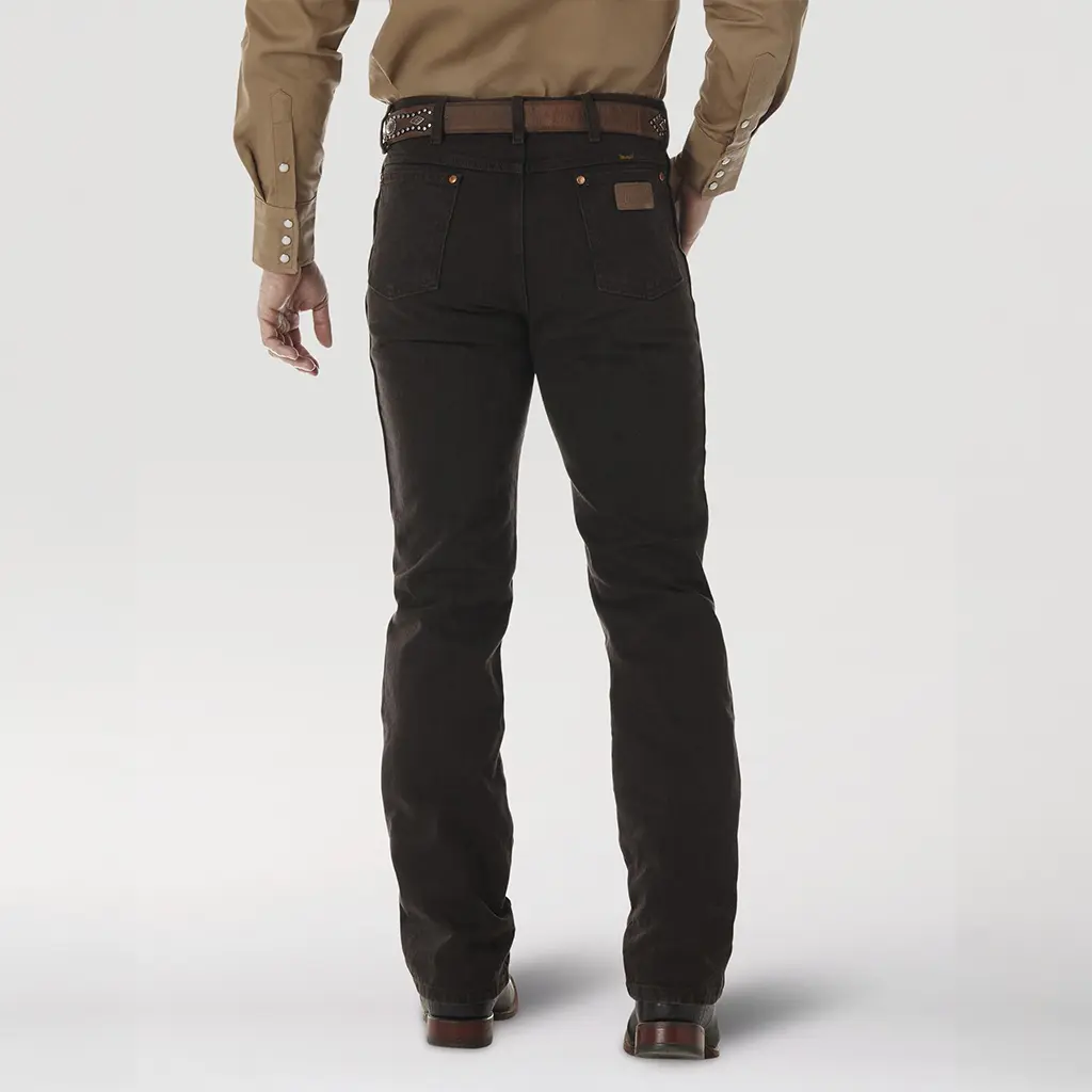 Rear studio view of the Wrangler Cowboy Cut Slim Fit Black Chocolate jeans highlighting the leather brand patch and signature 'W' pocket stitching.