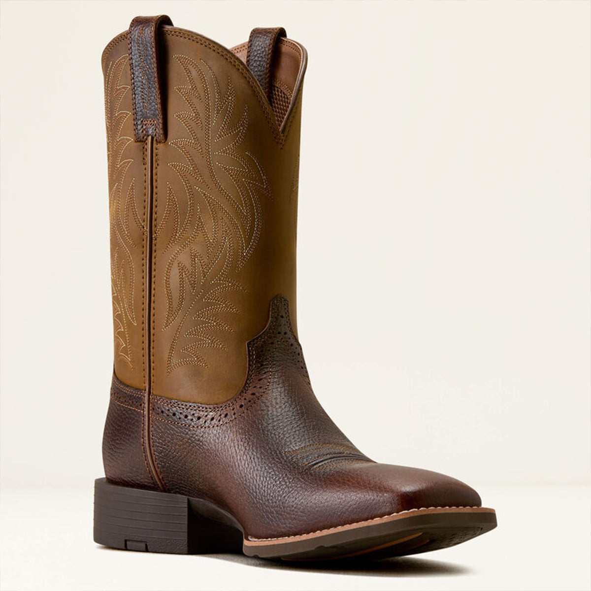 Ariat fiddle brown square toe cowboy boot with intricate design on a beige background.