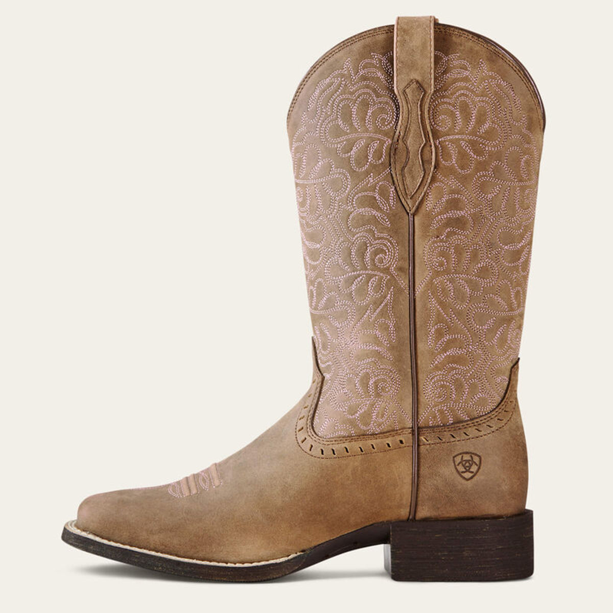 Side profile of Ariat tan square toe cowgirl boot with intricate embossing on a white background.