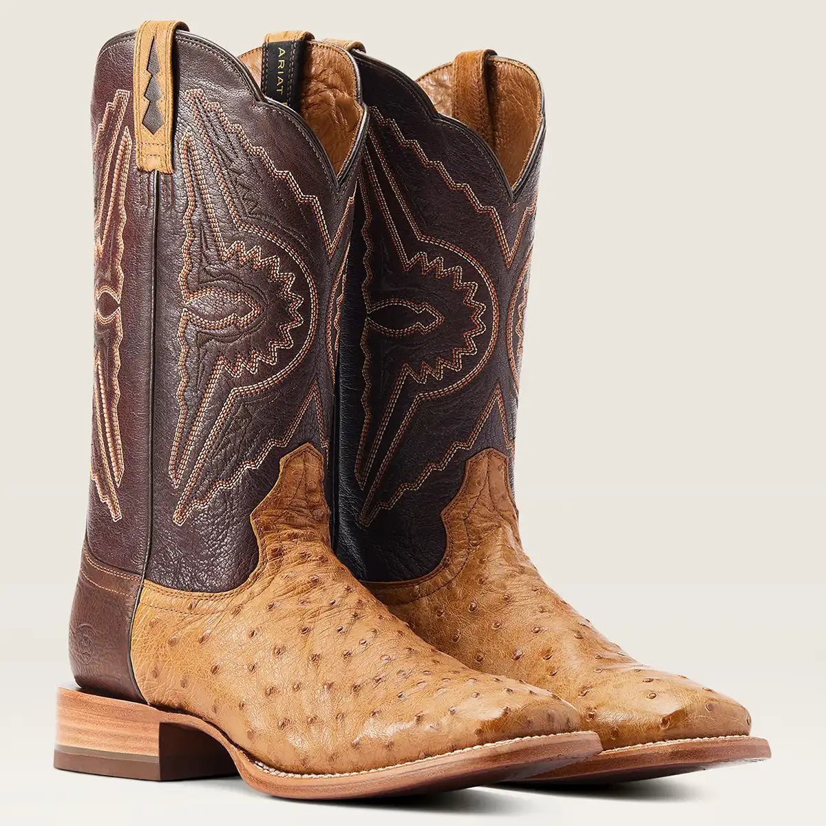 Pair of Ariat Men's Antique Saddle Western boots featuring a full-quill ostrich foot, bullhide heel counter, and dark brown embroidered shaft.