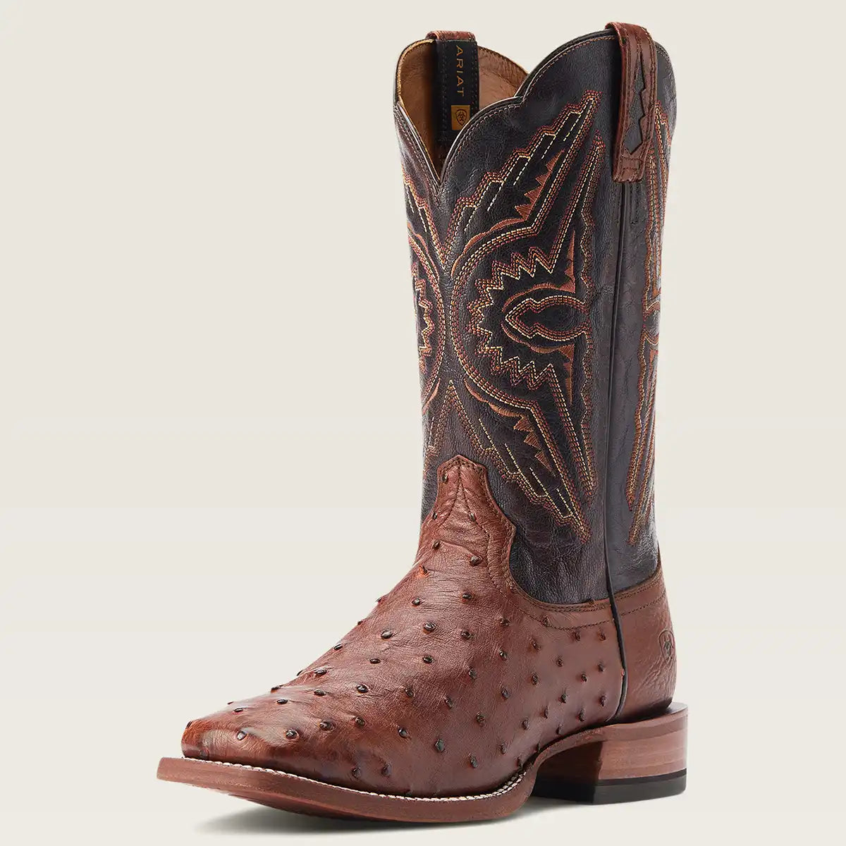 A single cowboy boot with a brown ostrich leather foot and a dark brown stitched shaft, shown against a light beige background.