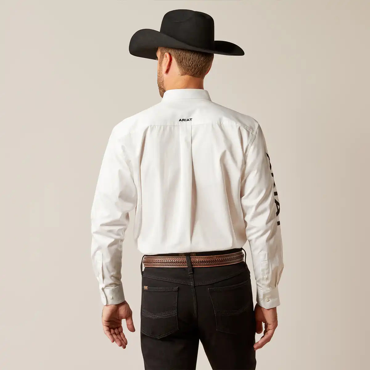 Back view of the Ariat white team logo shirt showing the back yoke embroidery and long tail fit.