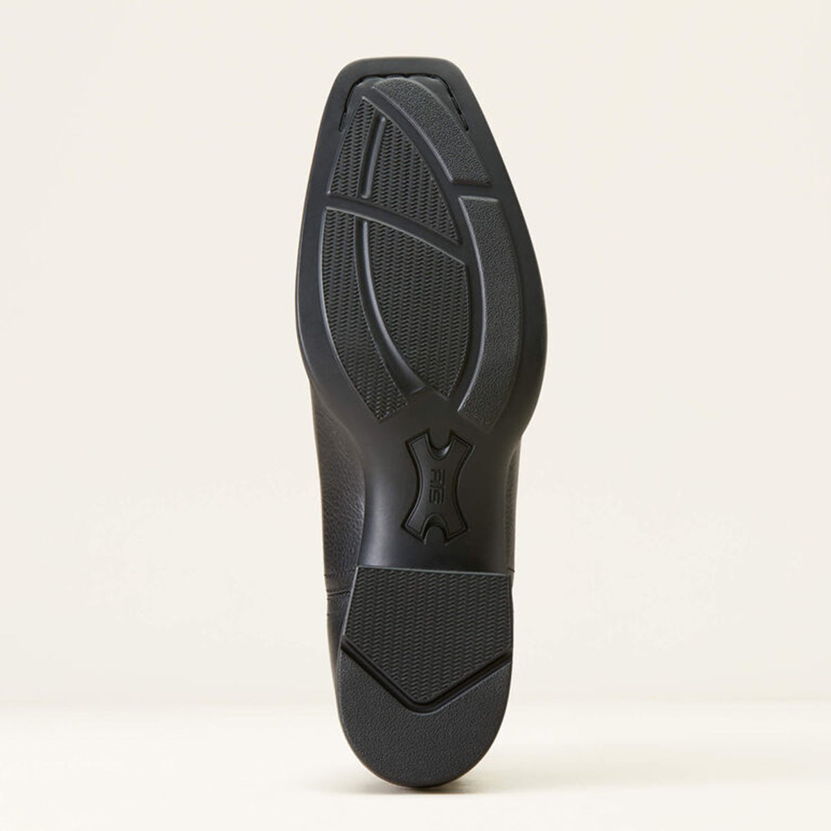 Black boot rubber sole on a light beige background.