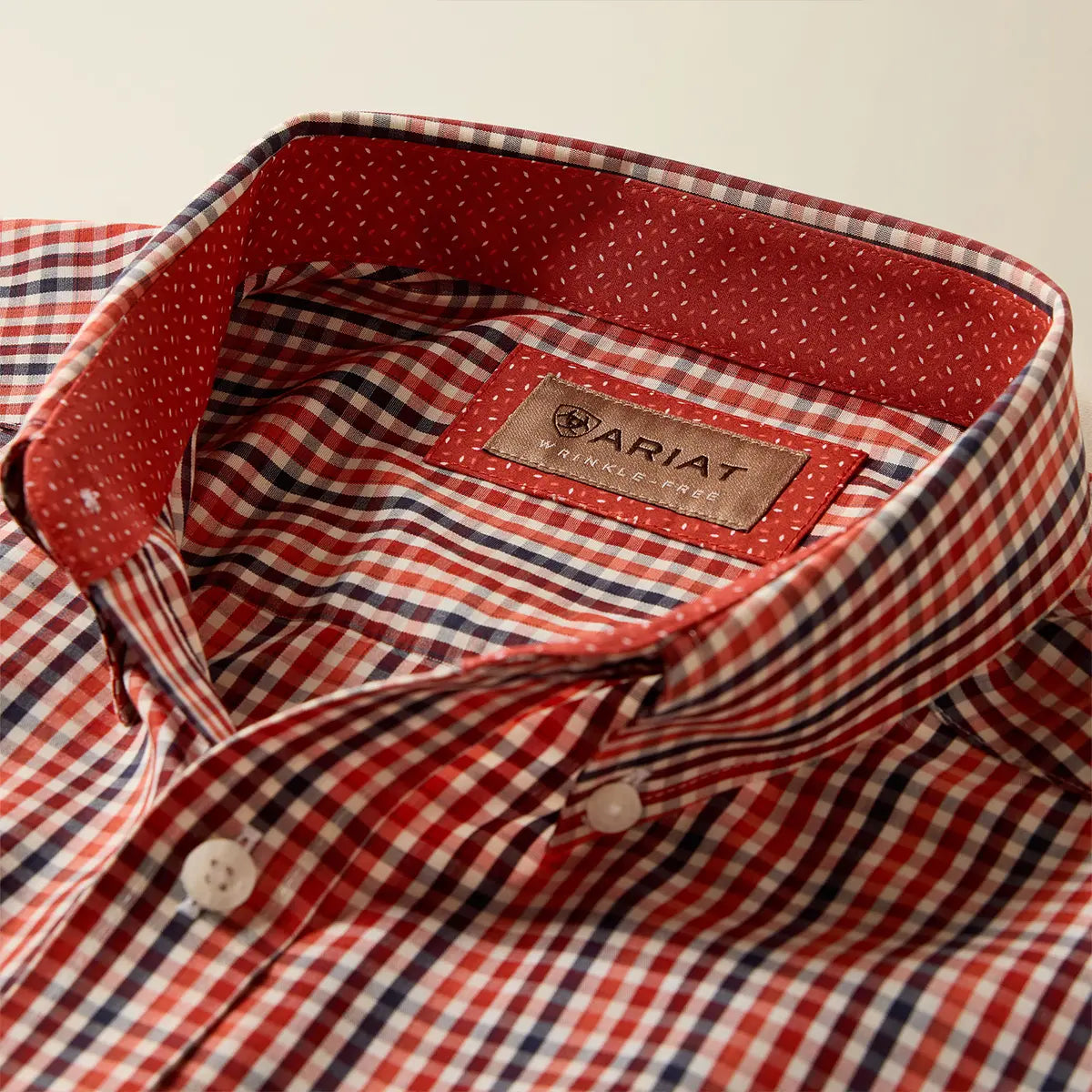 Close-up view of the inner collar on the Ariat Ketchup shirt displaying the Wrinkle-Free label and red micro-dot inner neckband.