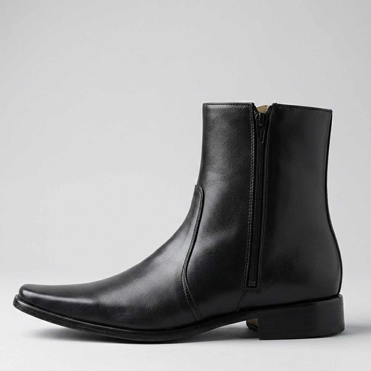 Men's black leather ankle boot with zipper on a light gray background.