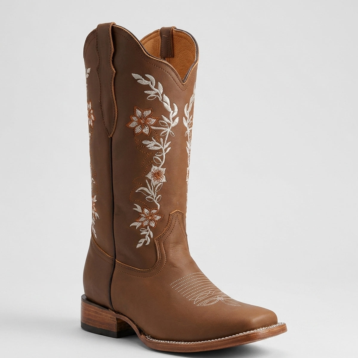 La Sierra women's light brown leather cowboy boot with white floral embroidery on the shaft, shown from a three-quarter angle against a light gray background.