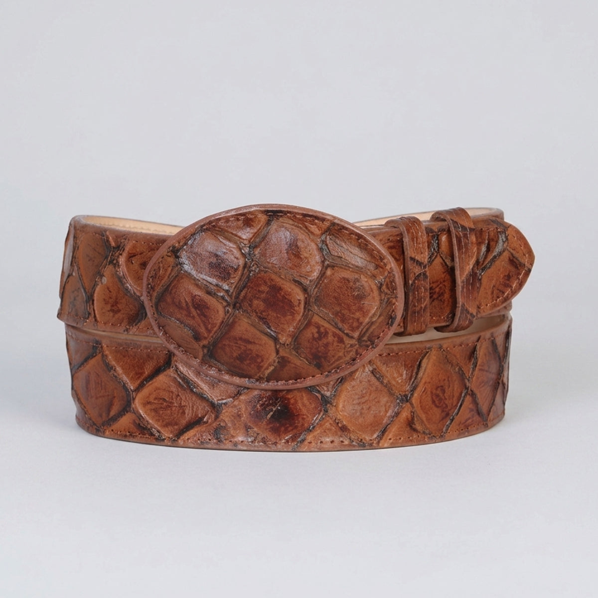 Almond brown pirarucu print belt with on a light gray background.