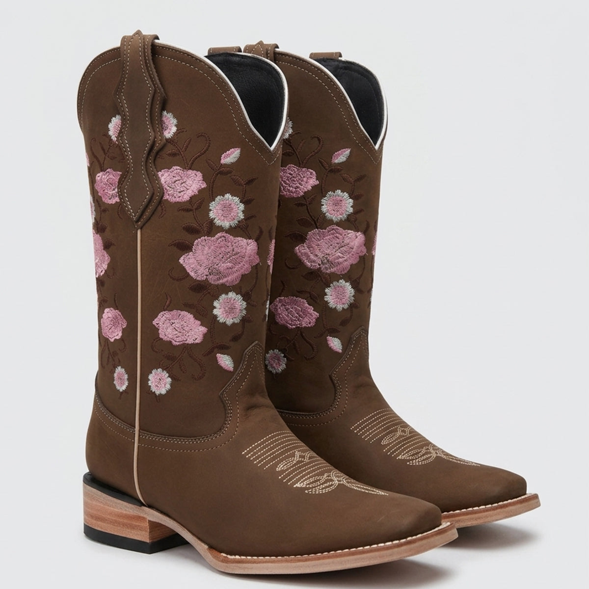 Women's brown leather square toe cowgirl boots with detailed pink and white embroidered roses and floral patterns on the shaft.