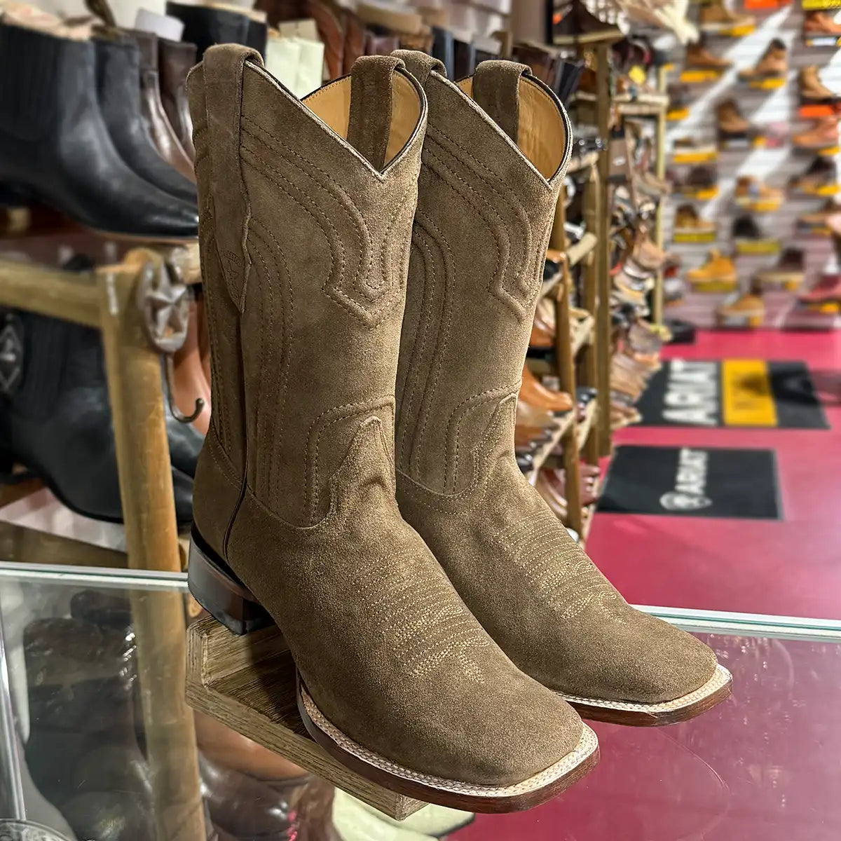 In-store counter display view of the Los Altos men's cappuccino brown suede cowboy boots showing the square toe and 12" shaft.