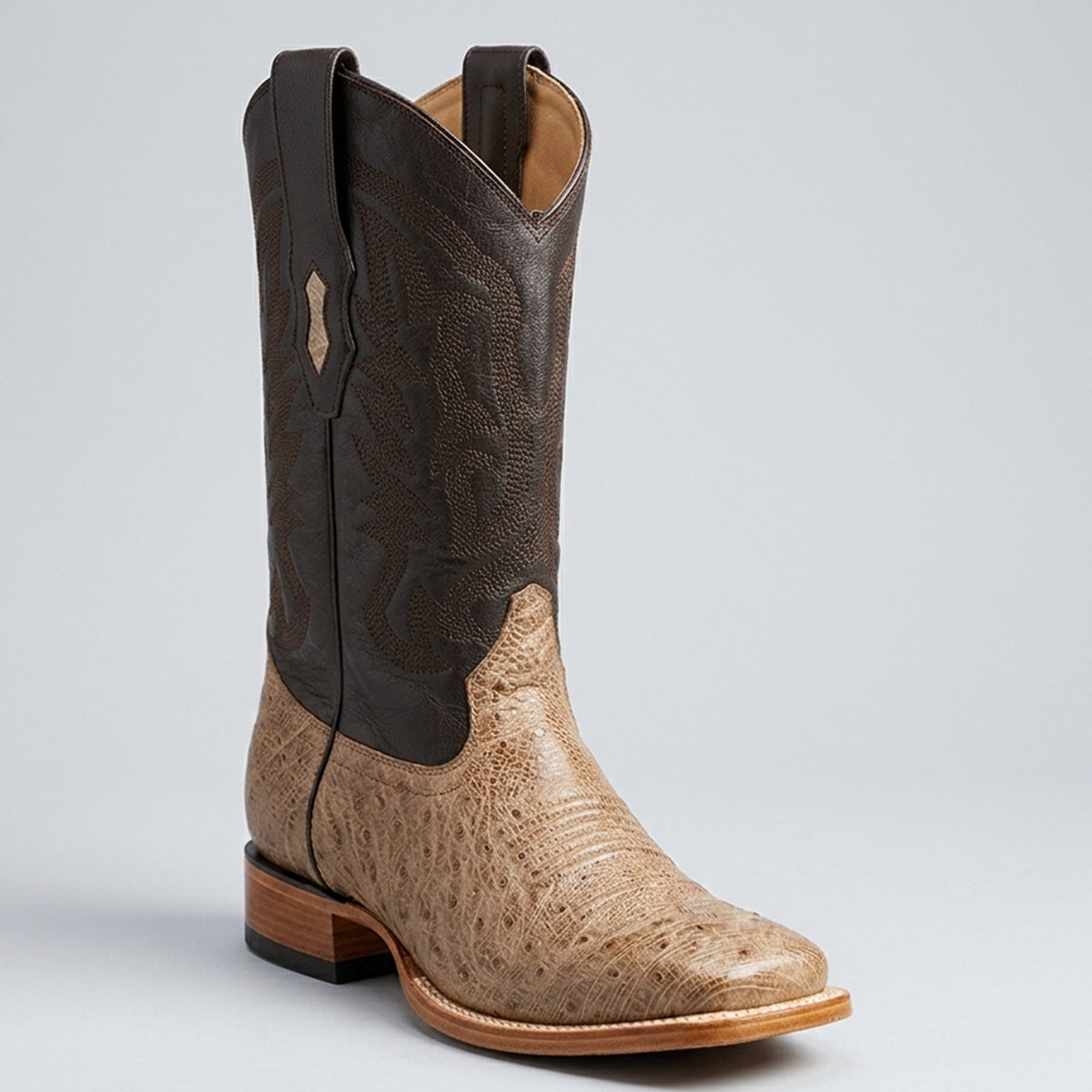 Los Altos Men's smooth ostrich leather cowboy boots featuring a tan oryx foot, wide square toe, dark brown embroidered shaft, and leather outsole.
