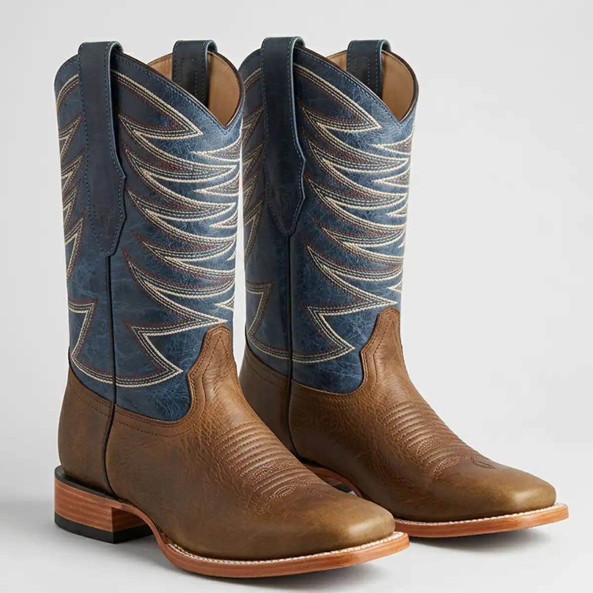 Pair of Los Altos Men's Honey brown leather square toe western boots with vibrant blue embroidered 12-inch leather shaft.