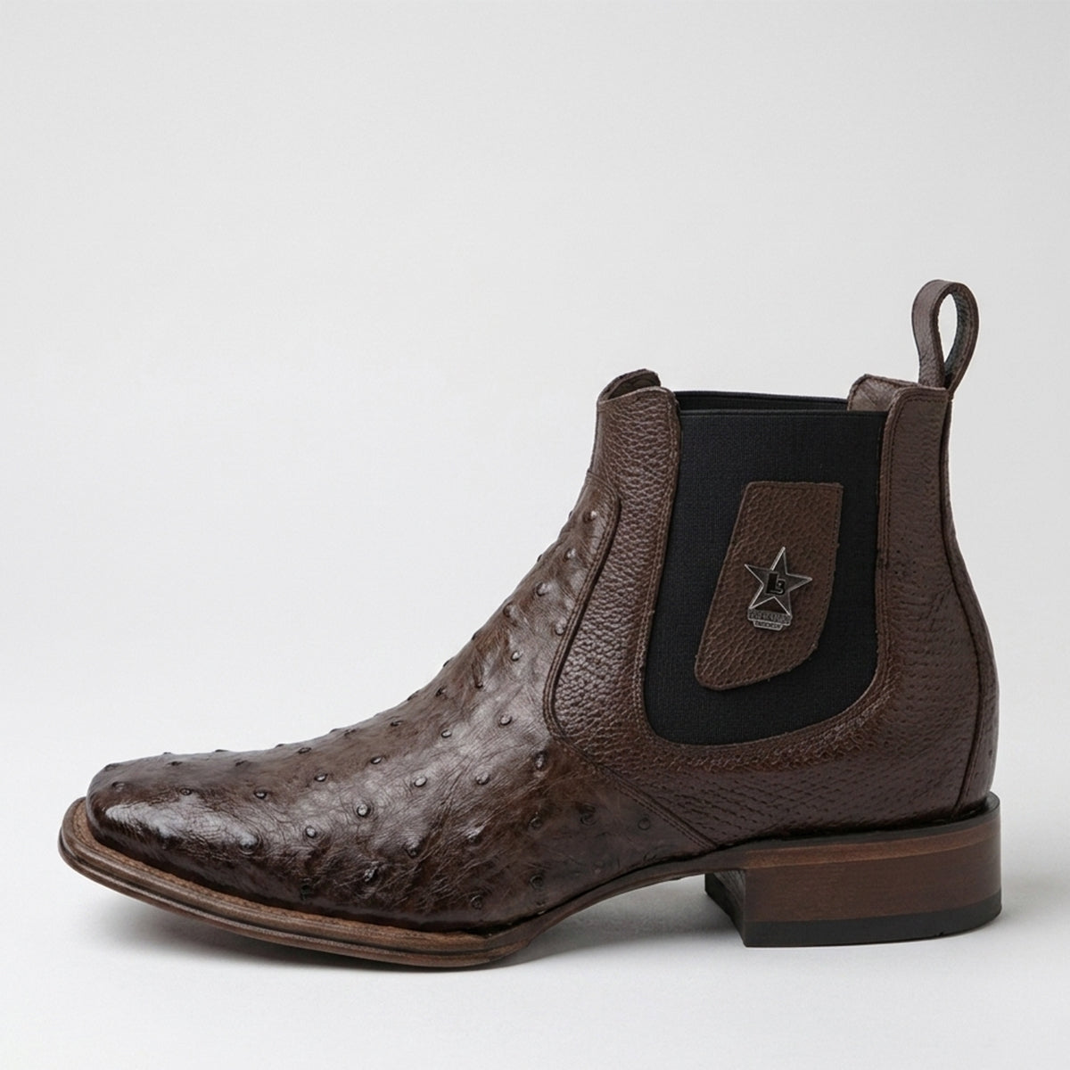 Los Altos men's dark brown ostrich leather Chelsea boot with black elastic side panels and a pull tab, shown from a side profile on a light gray background.