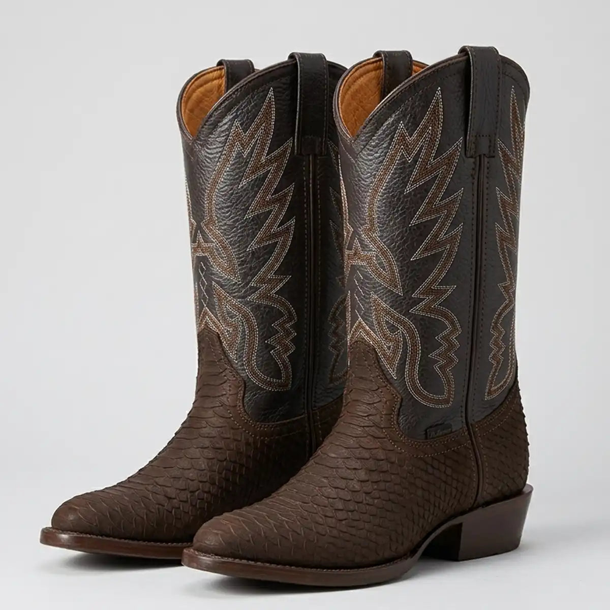 Studio shot of a pair of La Sierra men's dark brown matte python print skin cowboy boots with a traditional round toe and Western embroidered shaft.