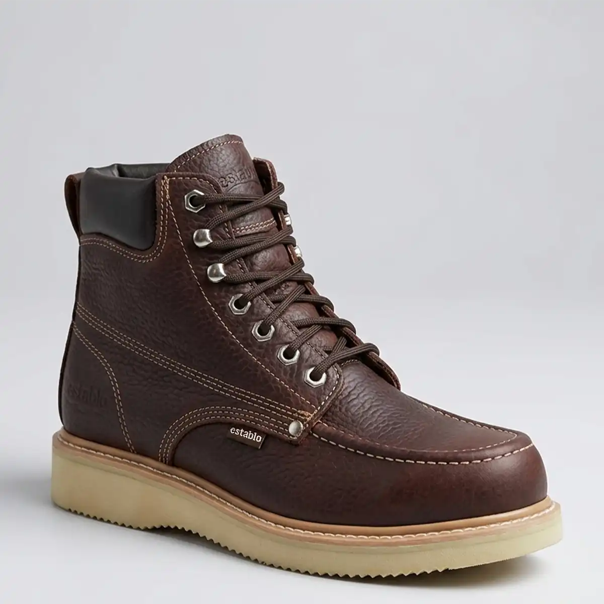 Studio side profile of the Establo Men's steel toe moc toe leather work boot showing the speed lace hooks and Goodyear welt stitch.