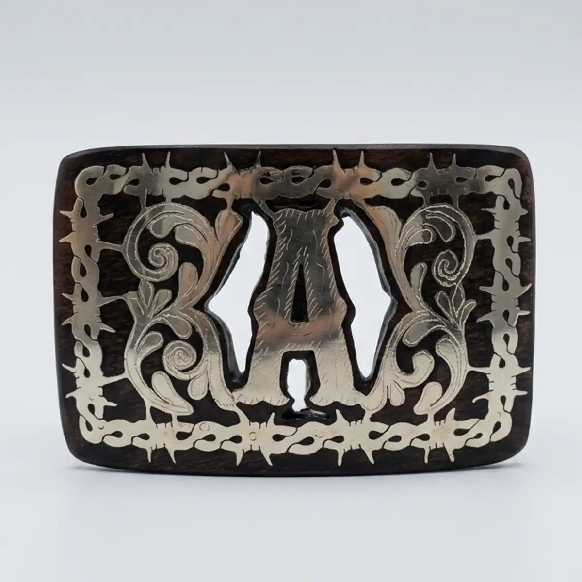 Studio white background view of the mesquite wood belt buckle highlighting the polished letter A and intricate scrollwork.