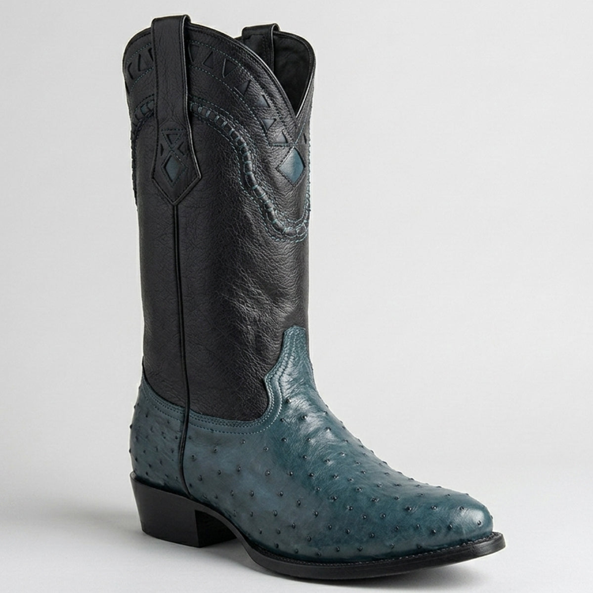 Black and blue ostrich full quill cowboy boot on a light gray background.