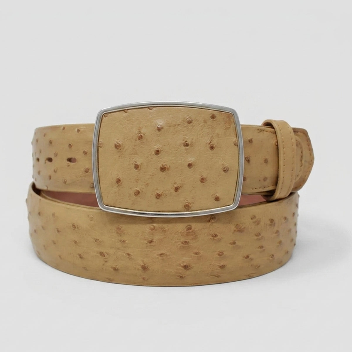 Los Altos tan ostrich leather belt with a silver-tone rectangular buckle, coiled on a light gray background.