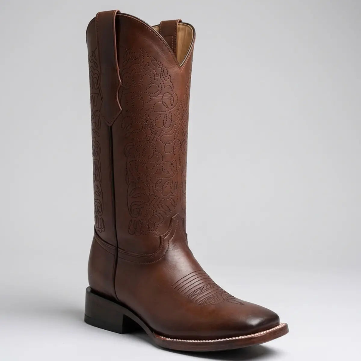 Studio single boot profile view of the Danna women's burgundy leather cowgirl boot displaying the 11-inch floral stitched shaft, square toe, and block heel.