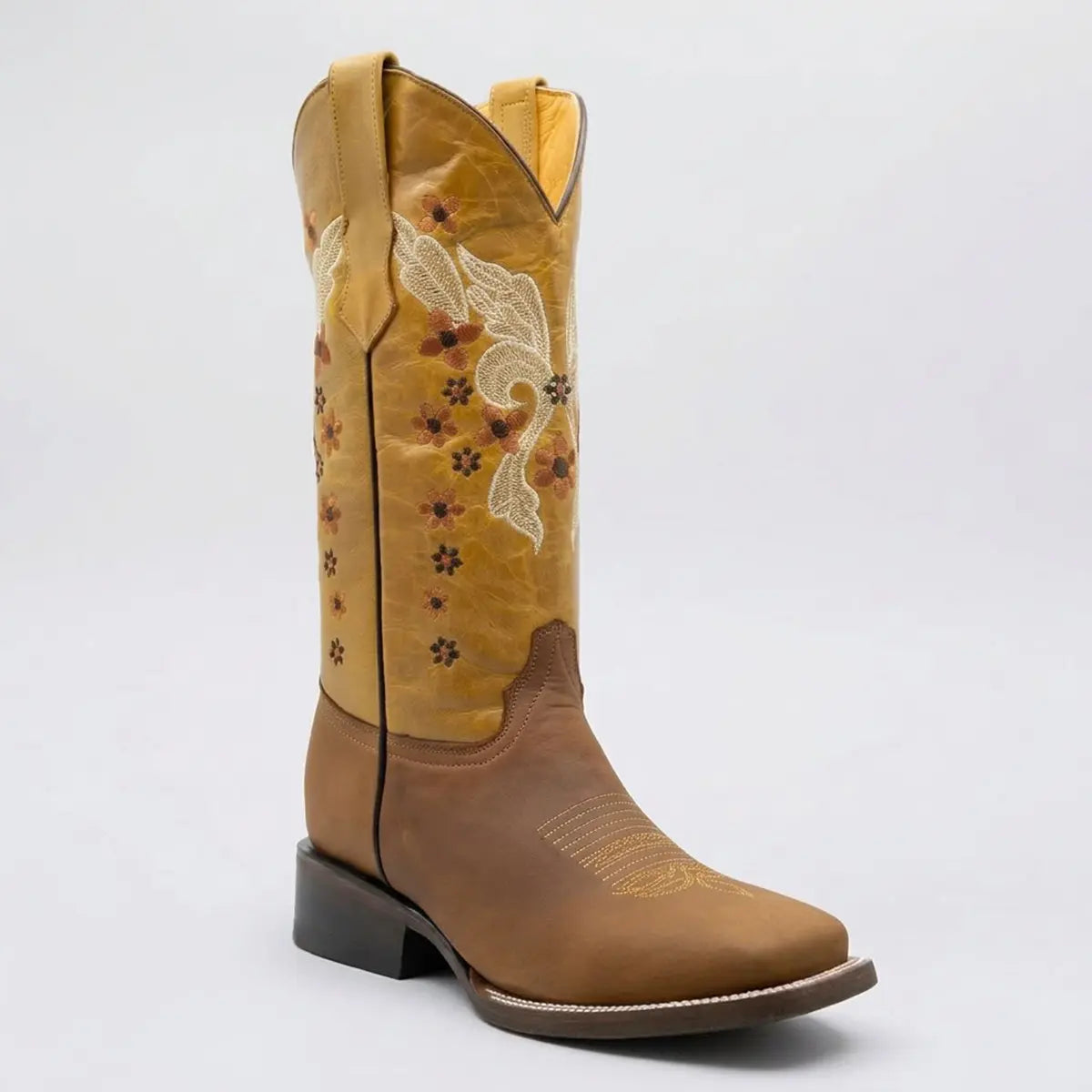 Studio profile view of a single Flowered Butterfly women's square toe Western boot showing the saddle tan foot, embroidered mustard shaft, and leather outsole.