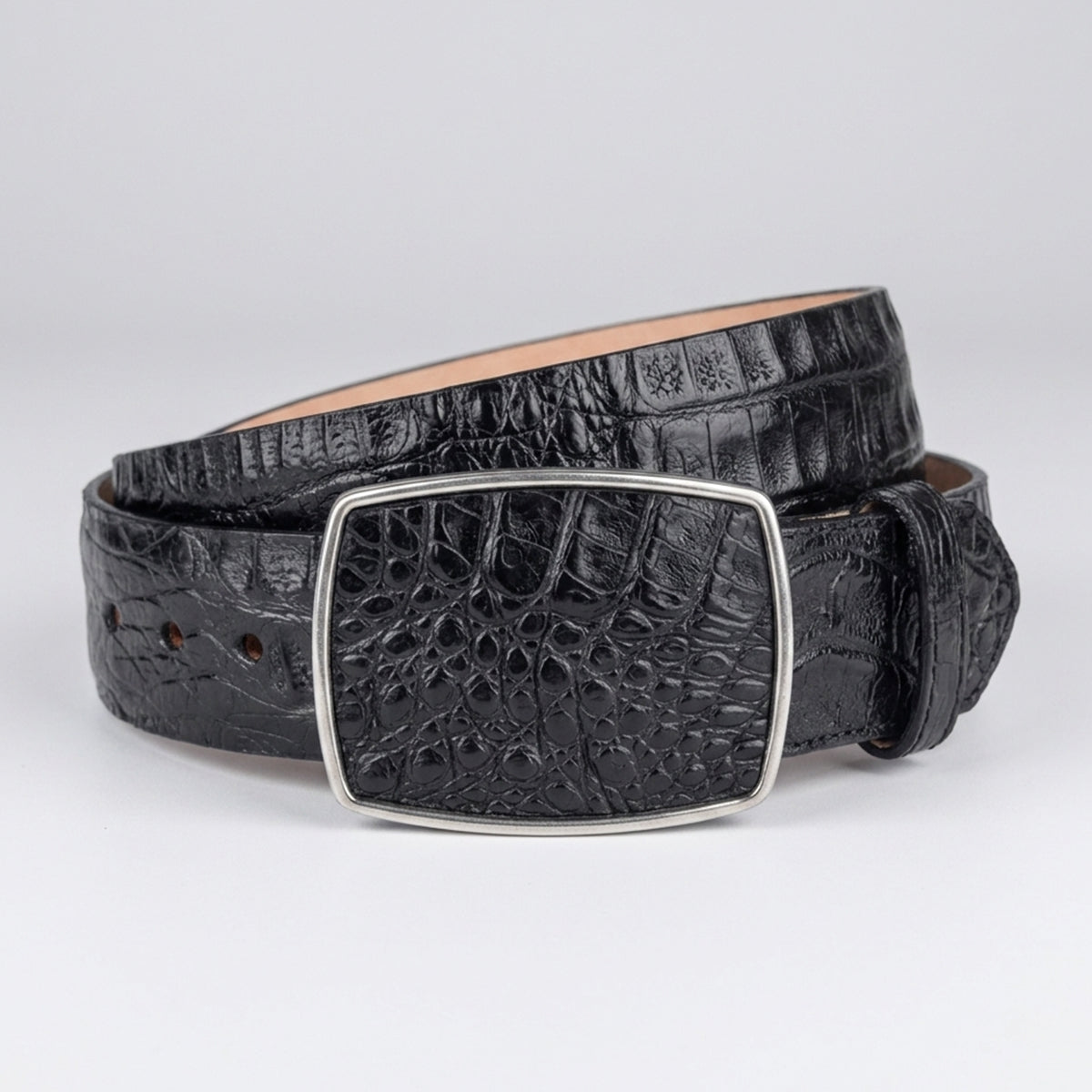 Los Altos men's black crocodile leather belt with a silver-tone rectangular buckle, coiled on a light gray background.