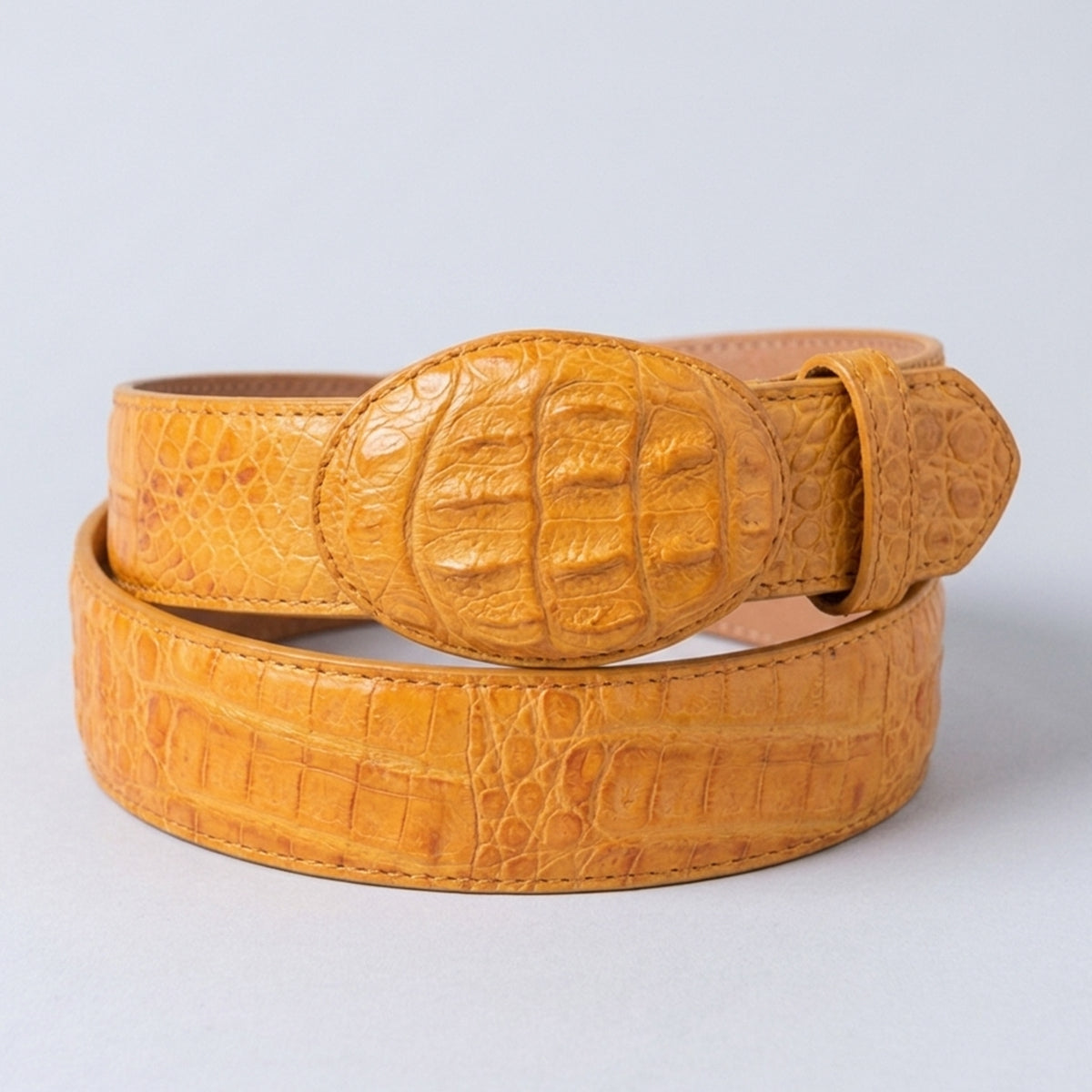 Los Altos men's yellow buttercup crocodile leather belt with a matching oval buckle, photographed on a light gray background.