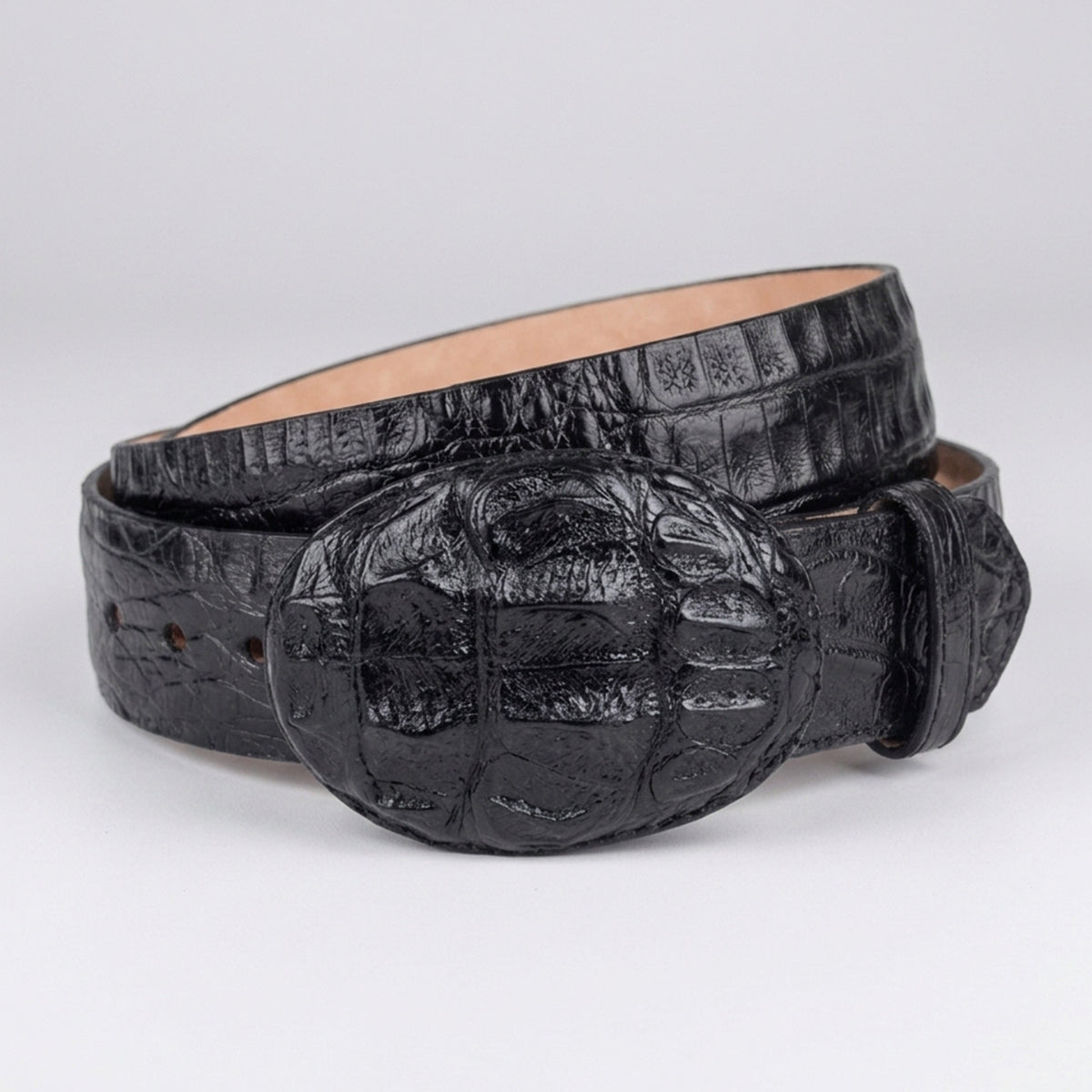 Los Altos men's black crocodile horn-back leather belt with an oval buckle, coiled on a light gray background.