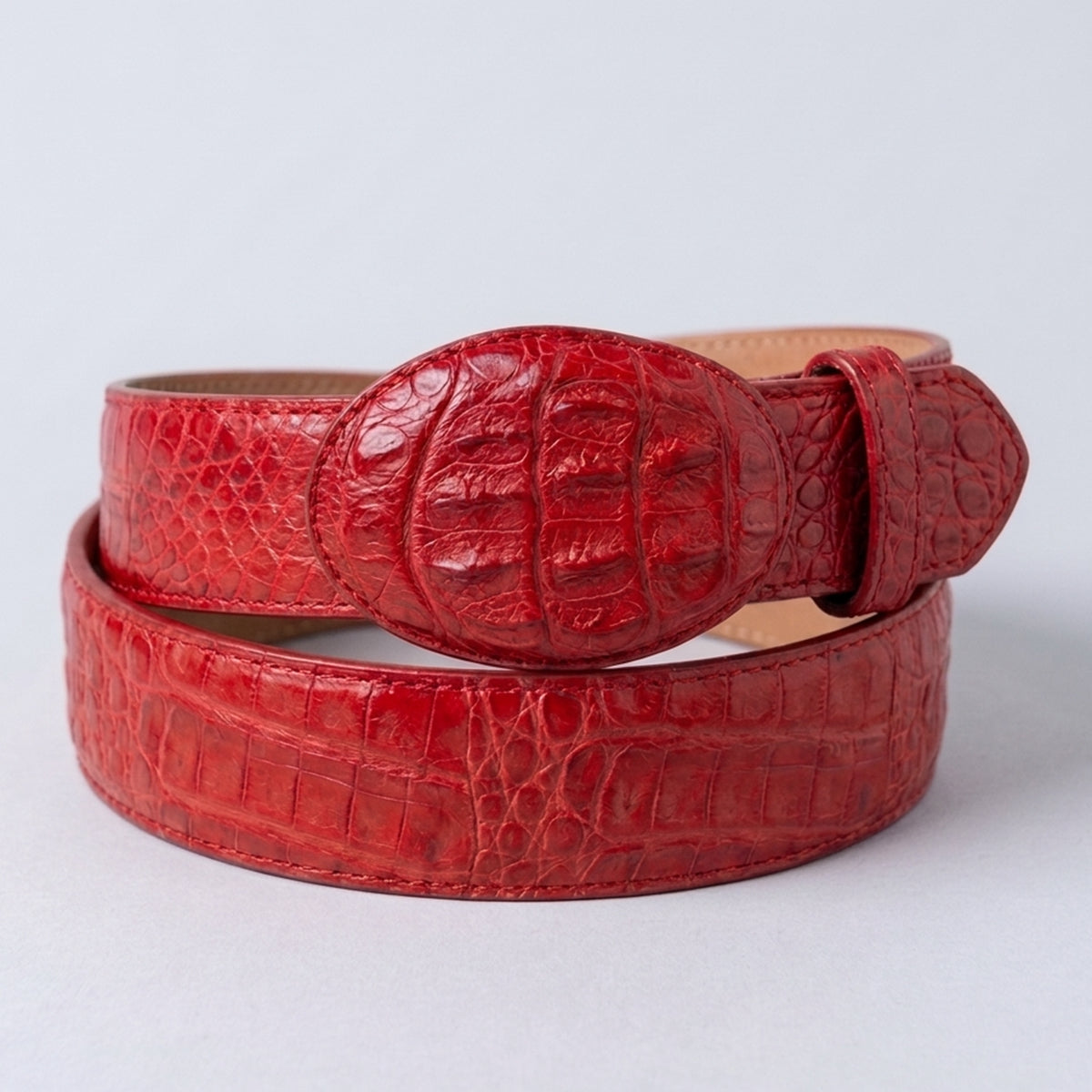 Los Altos men's red genuine caiman hornback leather belt showing prominent raised dorsal ridges and a matching oval leather-wrapped buckle.