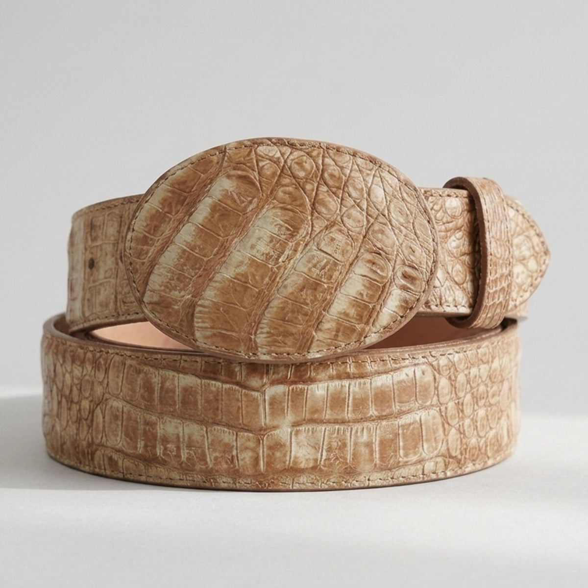 Los Altos men's Sahara Oryx genuine caiman belly leather belt showing a two-tone honey beige colorway and an oval buckle wrapped in reptile scales.
