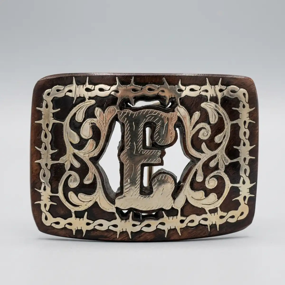 Studio white background view of the mesquite wood western belt buckle highlighting the polished letter E and intricate scrollwork.