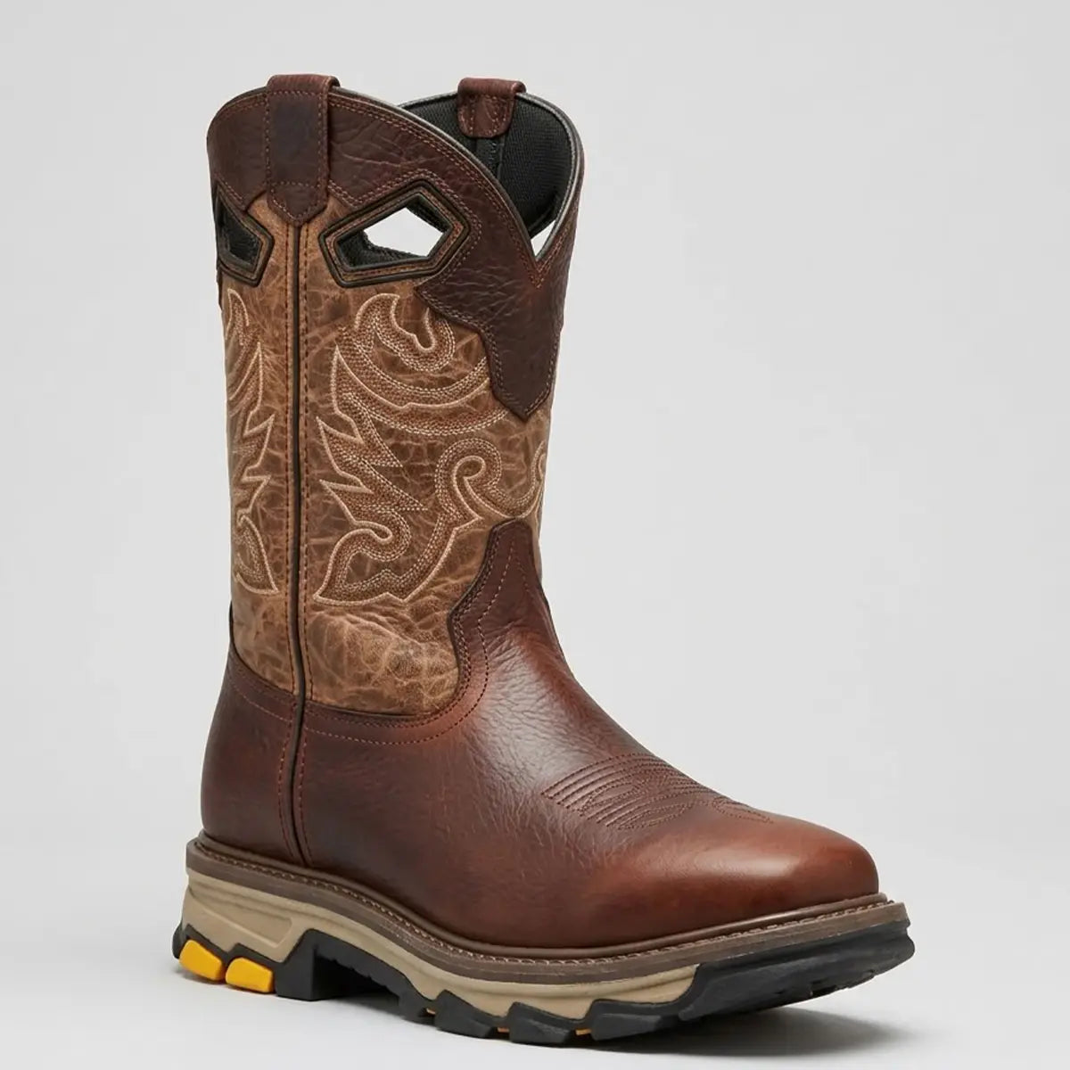 Studio angled view of the El General men's bull shoulder leather work boot showcasing the heavy-duty tractor rubber sole, square toe profile, and embroidered two-tone upper shaft.