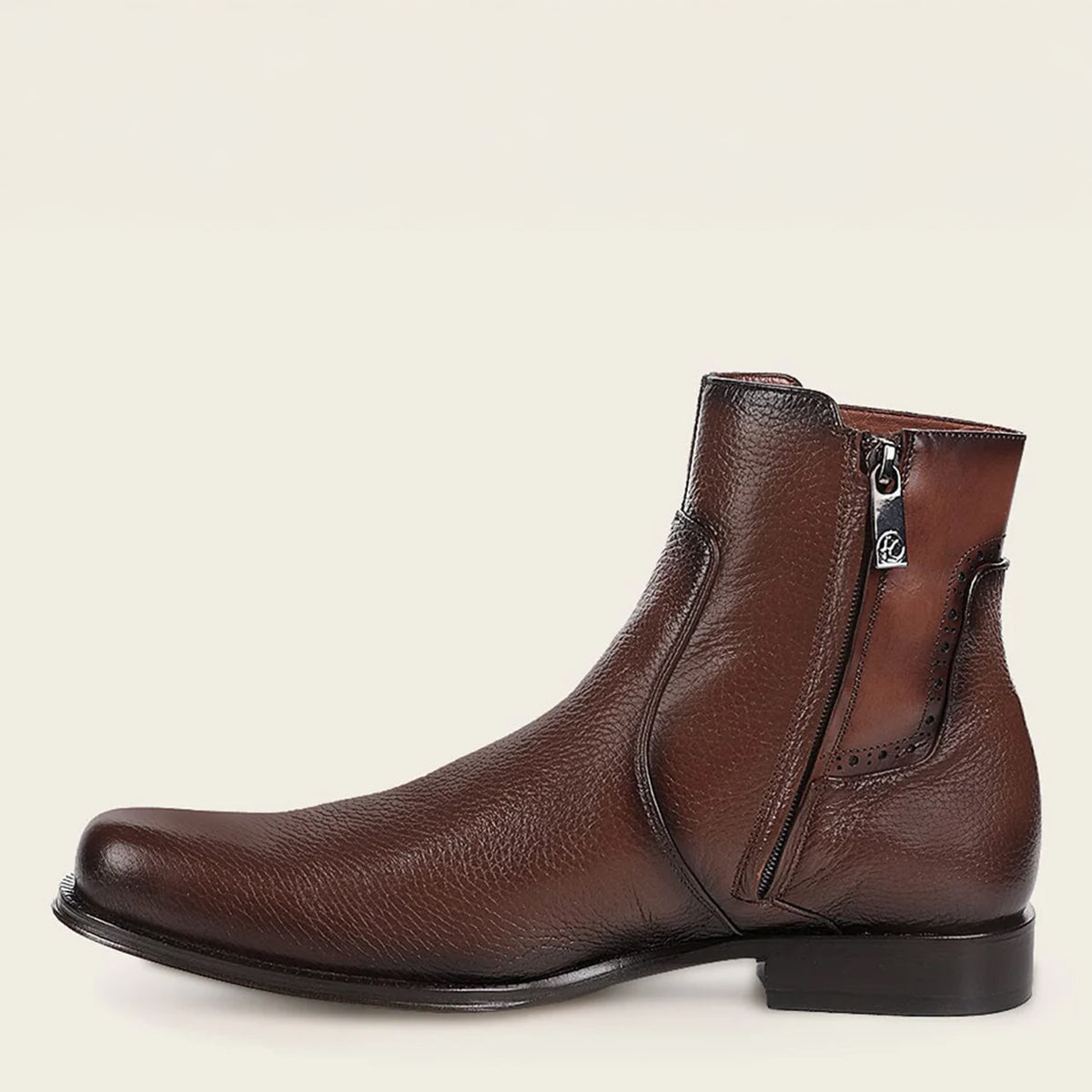 Cuadra men's brown leather Chelsea boot with a zipper on a beige background.