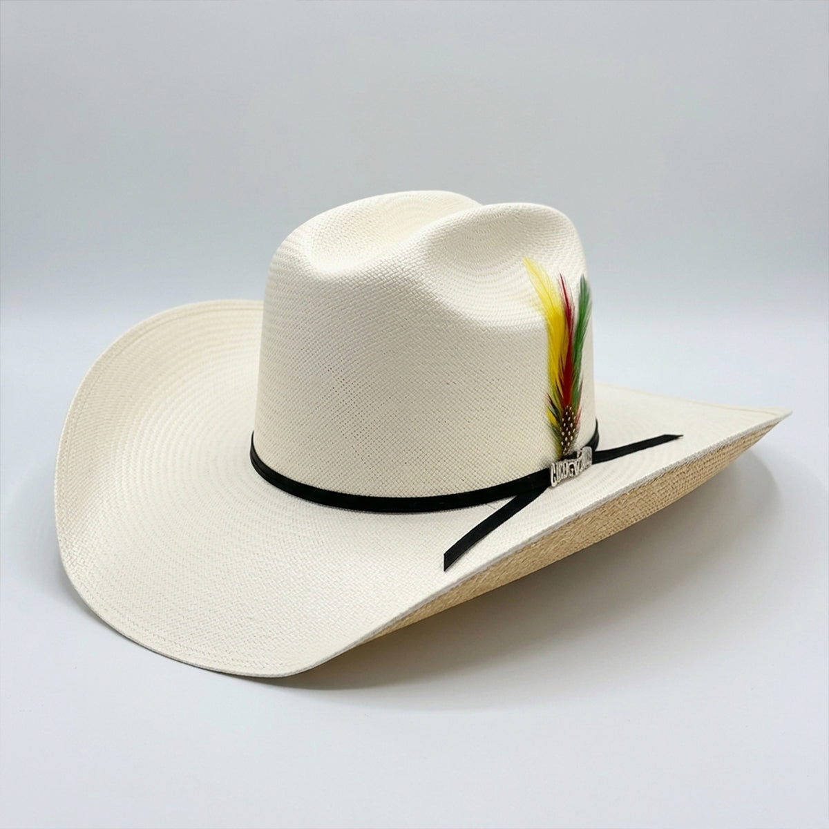 Cuernos Chuecos 100x Gorge straw cowboy hat with feather and ribbon band.