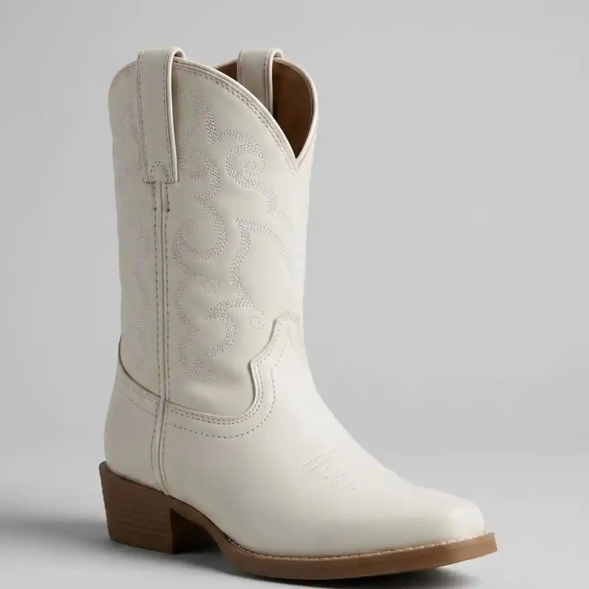 Single boot profile shot of the Justin Kids' Bronci Junior white boot showing the rubber sole and unit heel.
