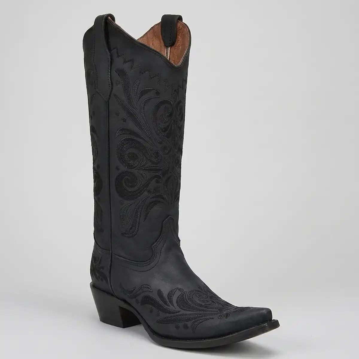 Corral Women's black leather cowboy boot featuring intricate black tonal embroidery, a sharp snip toe, and a 3-inch stacked heel.