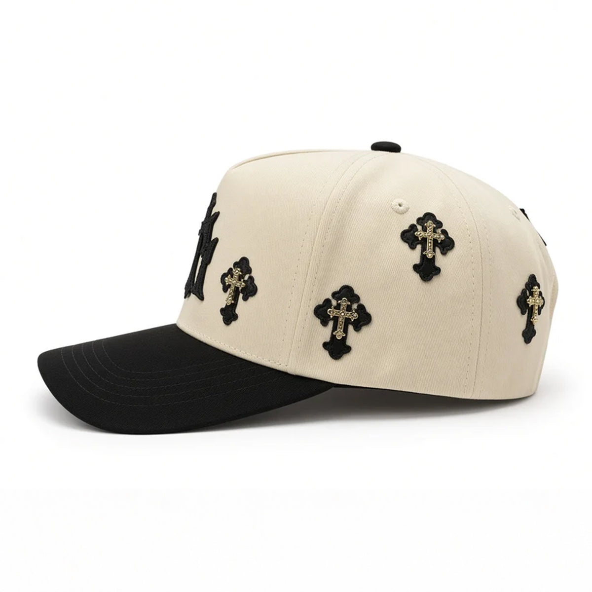 Left side view of the Klan Hats LA Chrome cap showing the beige crown panels with multiple gold and black cross appliques.