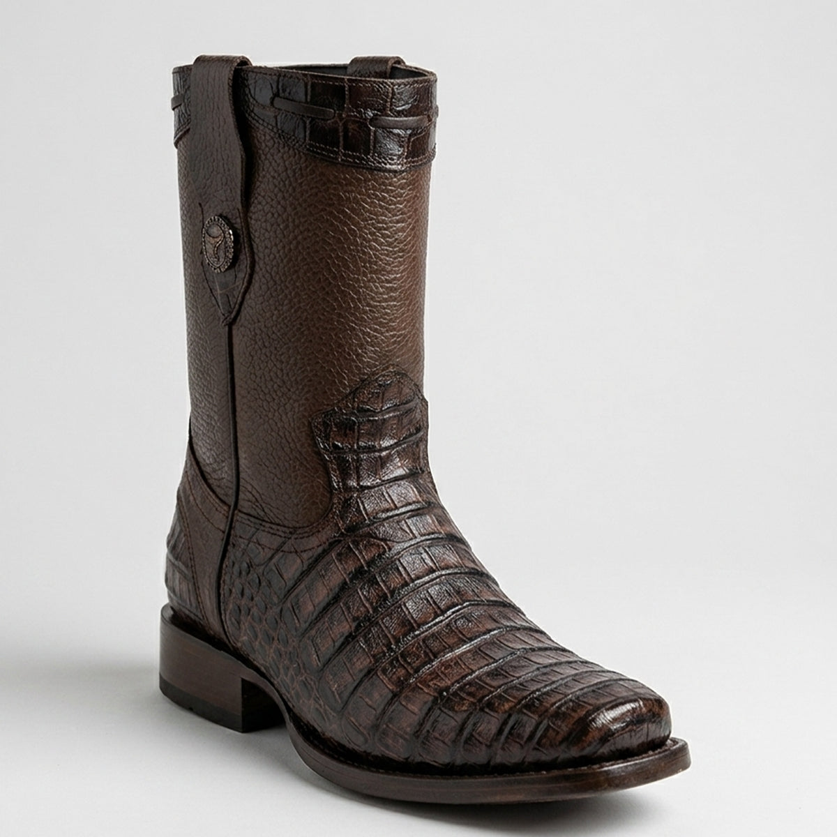 A dark brown western boot featuring a textured pebbled shaft and a fully crocodile-embossed toe, heel, and pull strap, shown against a light gray background.