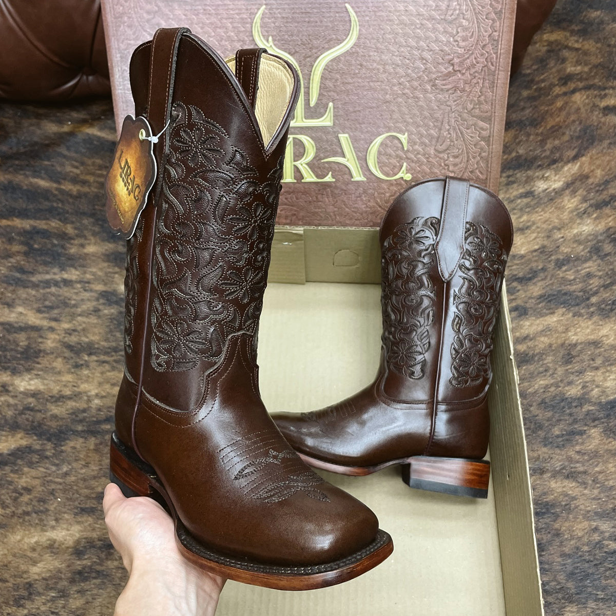 Pair of women's Lirac Toscana brown cowboy boots with intricate designs.