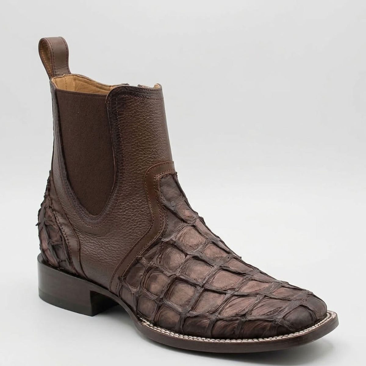Single studio profile view of the Los Altos faded tobacco pirarucu boot showcasing the exotic scale vamp, wide square toe, side stretch panel, and leather sole.