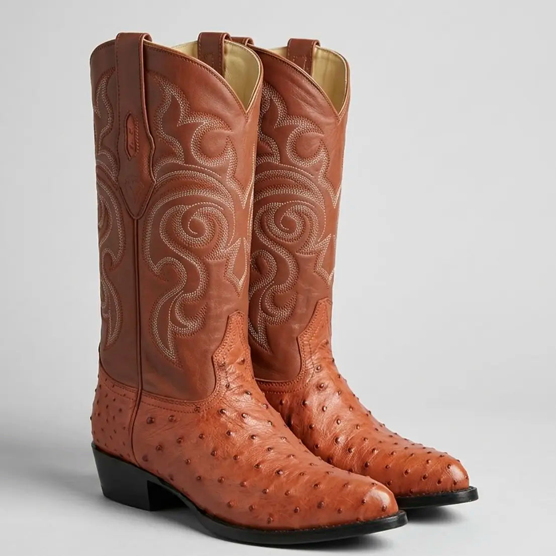 Pair of Los Altos Men's Cognac genuine full quill ostrich Western boots featuring a pointed J-toe profile, 13-inch embroidered leather shaft, and leather outsole.
