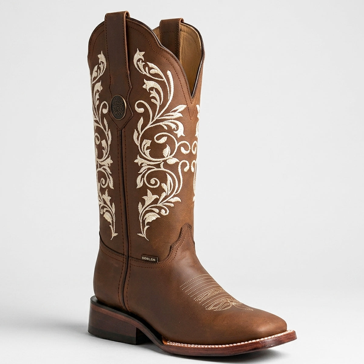 Botas Doble R women's brown leather square toe cowgirl boots featuring intricate ivory floral scrollwork embroidery along the shaft.