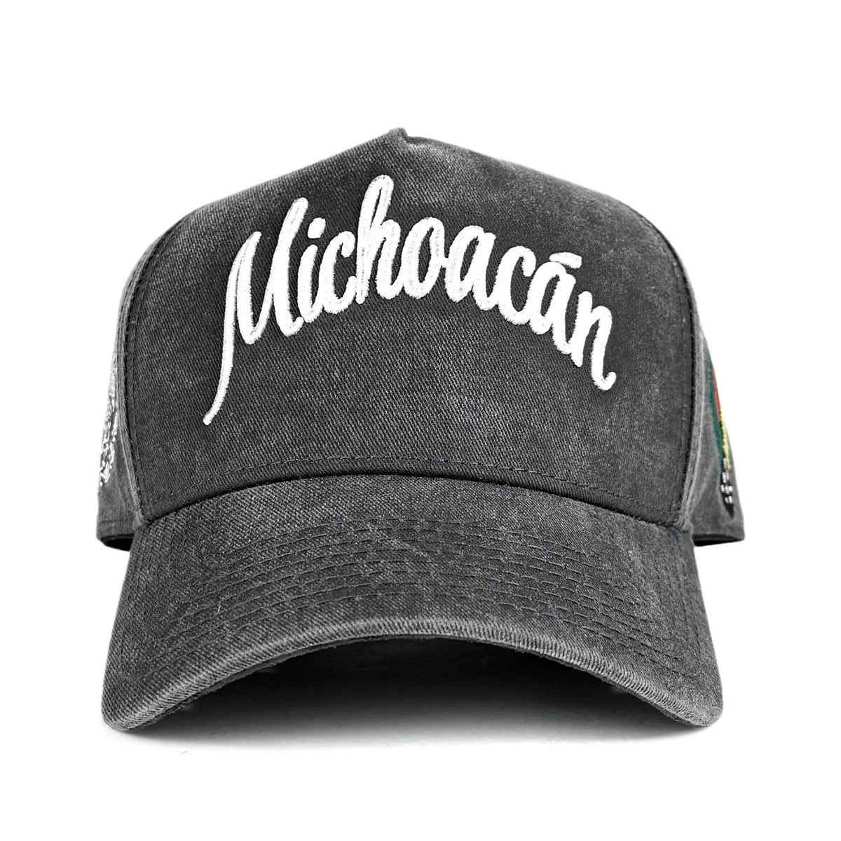 A dark gray washed baseball cap featuring the word 'Michoacán' embroidered in white script across the front, shown against a plain white background.