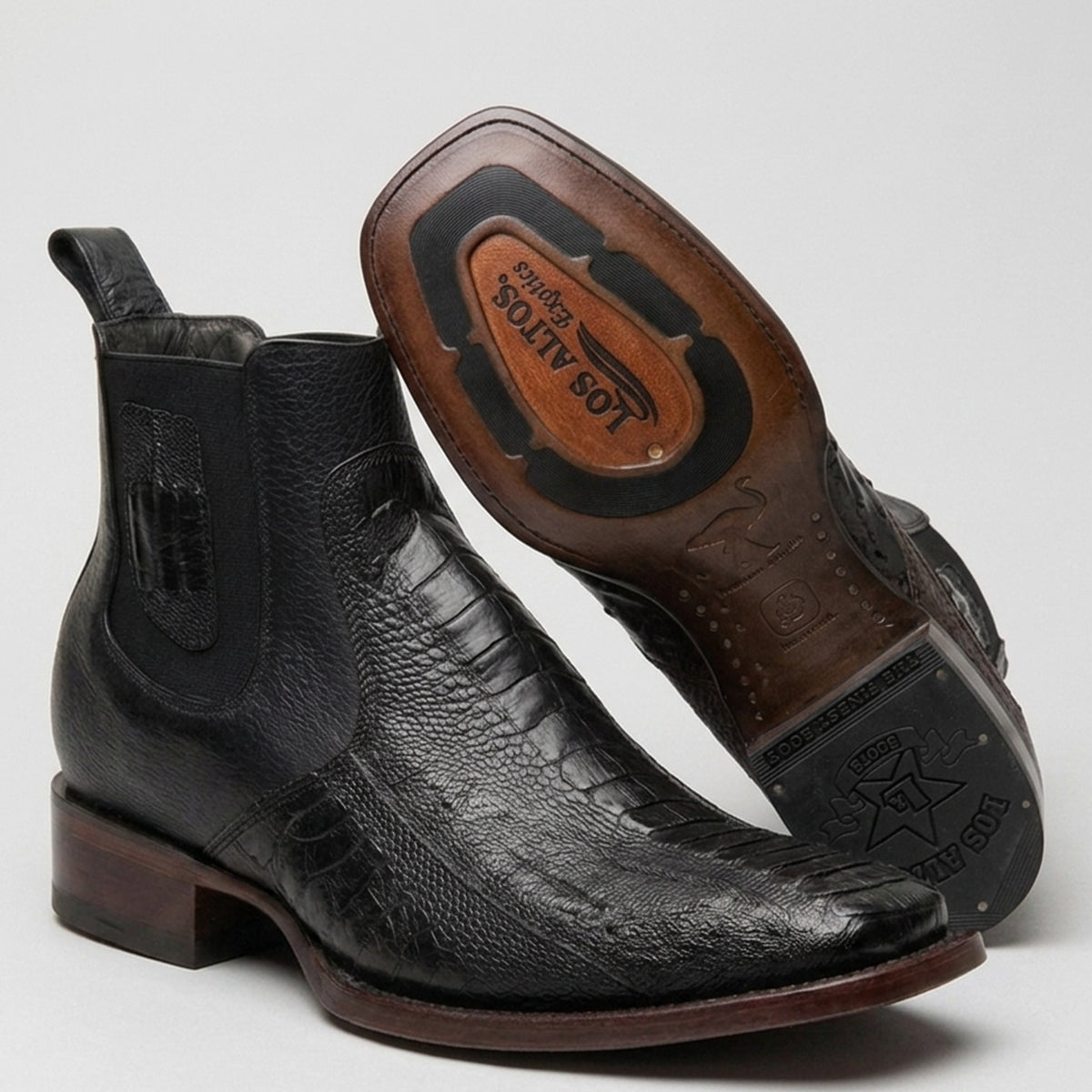 A pair of Los Altos men's black ostrich leg leather ankle boots, shown from the side and from the sole, on a light gray background.