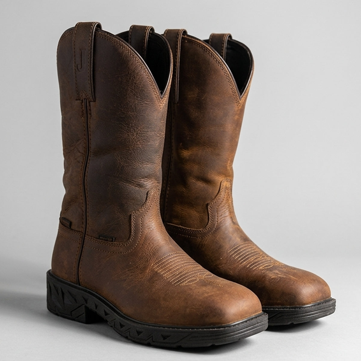 Justin Trencher 11-inch waterproof brown water buffalo leather steel toe work boots with square toe and slip-resistant rubber sole.