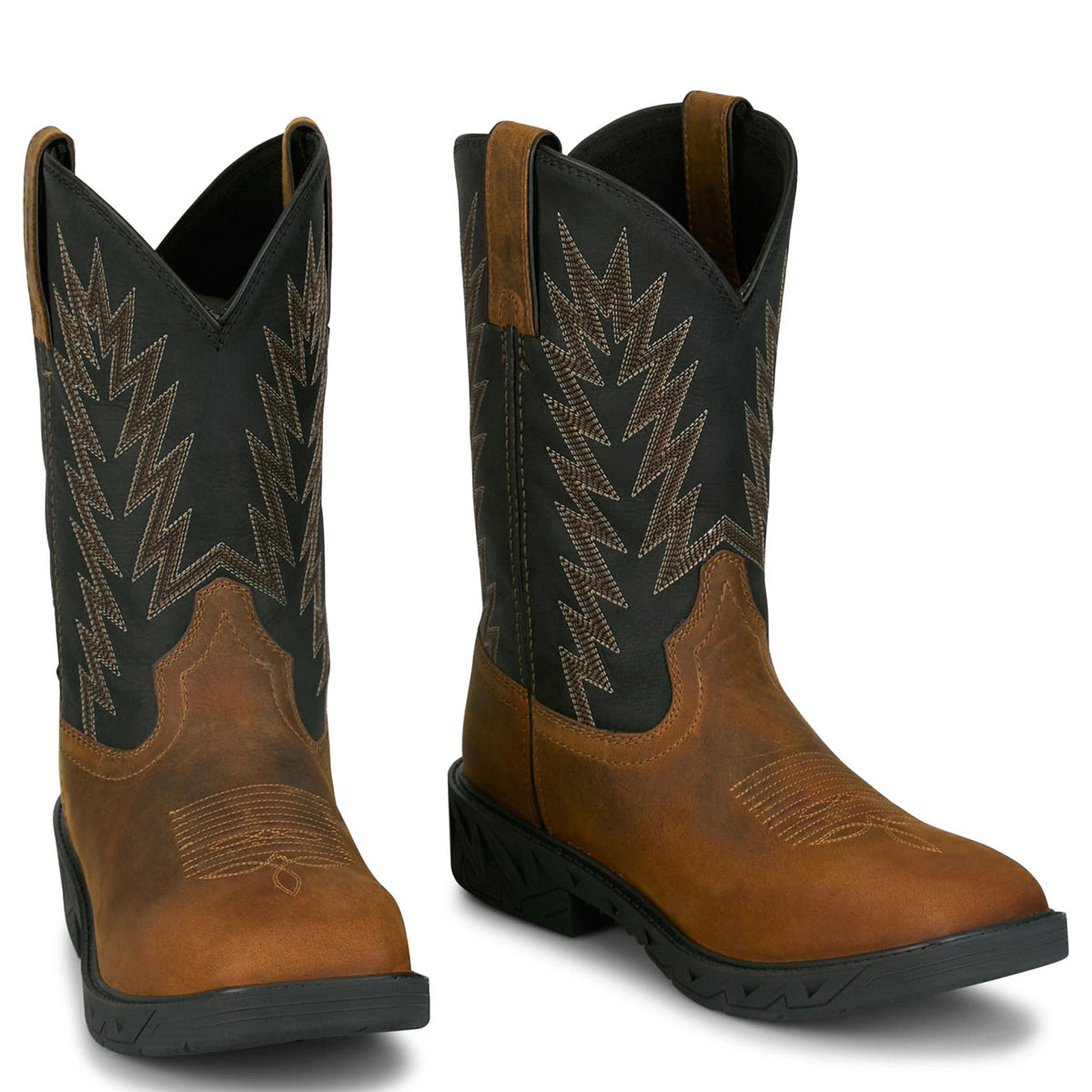 Pair of Justin brown and black square toe cowboy work boots with intricate stitching on a white background.
