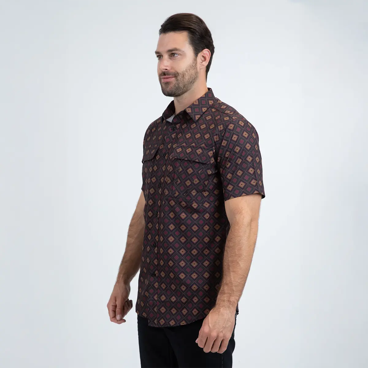 Three-quarter side view of a male model wearing the Platini black micro-diamond grid short sleeve shirt.