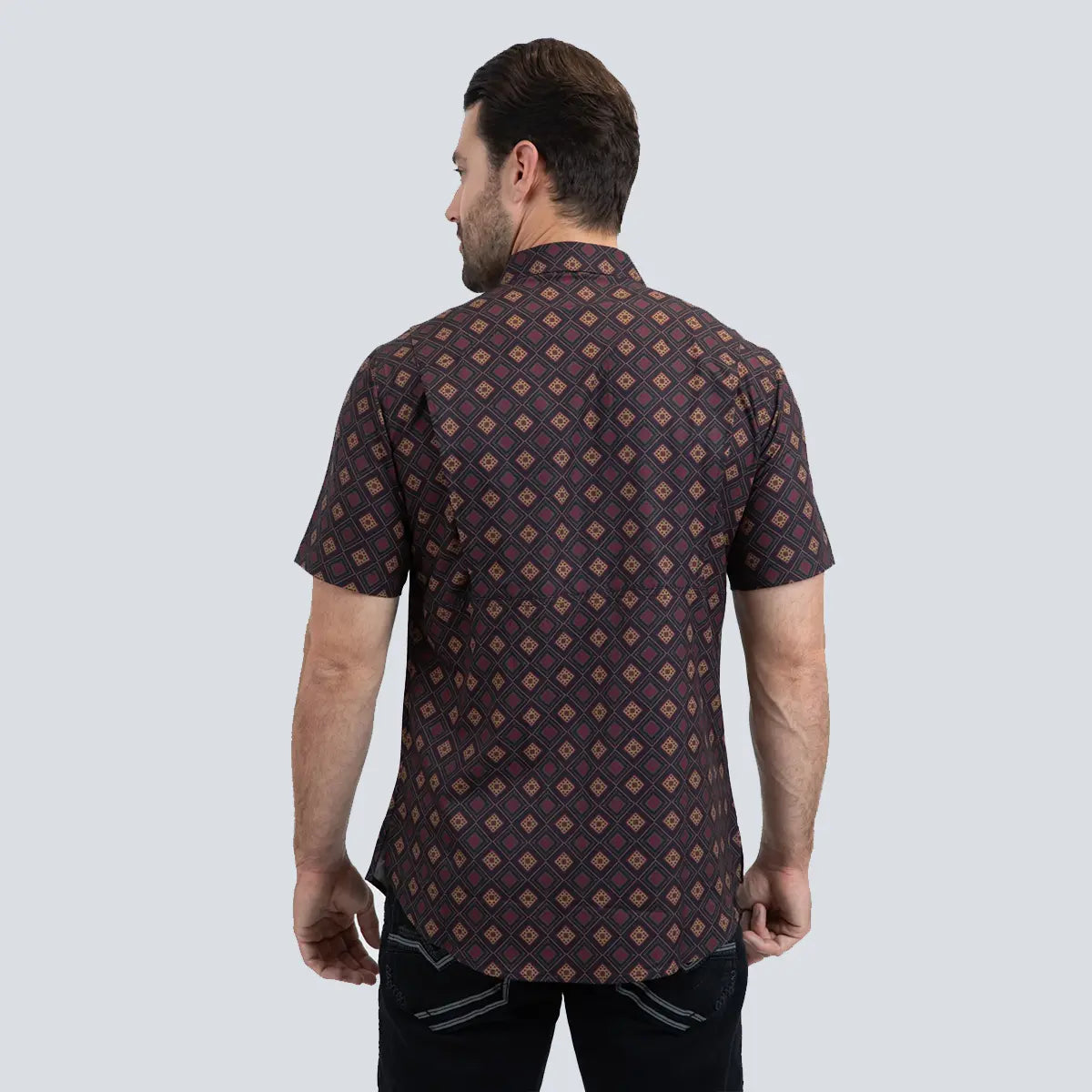 Back view of a male model wearing the Platini black short sleeve performance shirt highlighting the geometric pattern alignment.