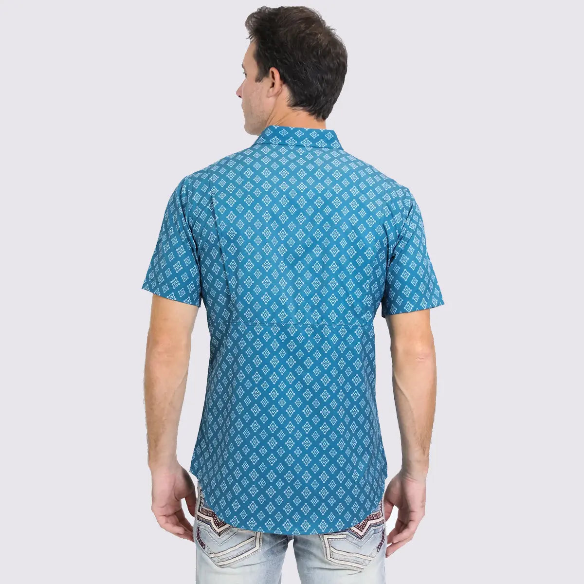 Back studio view of a male model wearing the Platini blue performance shirt showing the back shoulder cape ventilation and geometric pattern alignment.