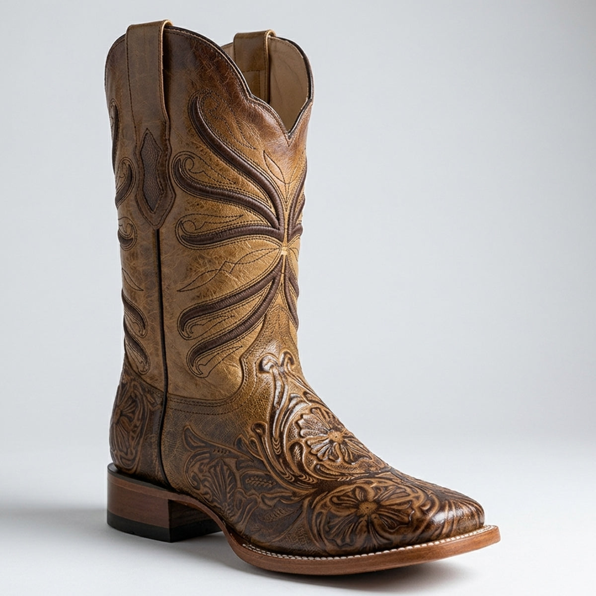 Quincy men's light brown tooled square toe cowboy boot with intricate embossing on a light gray background.