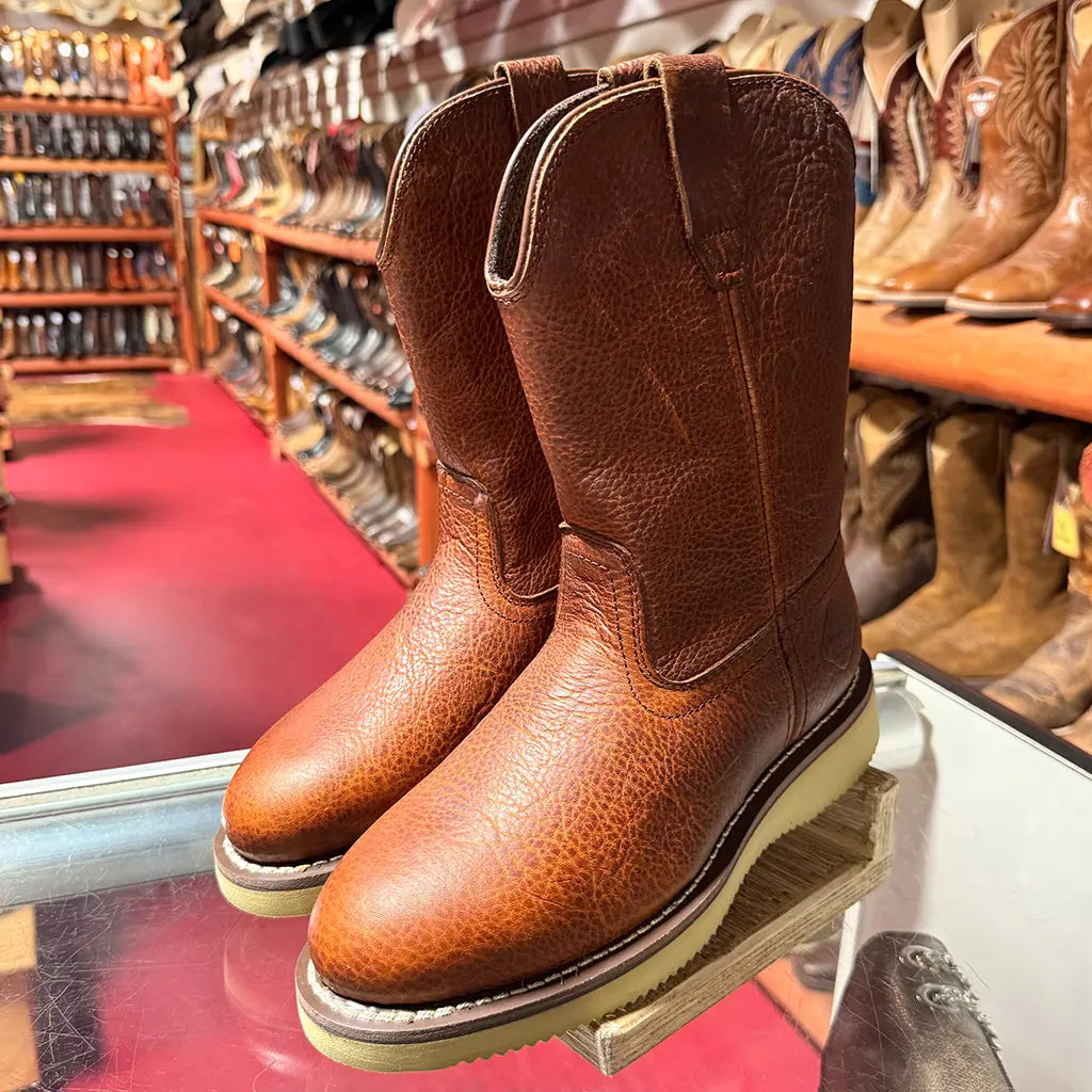 In-store display view of the Work Zone S997 steel toe Wellington boots sitting on a glass counter inside a Western workwear store.