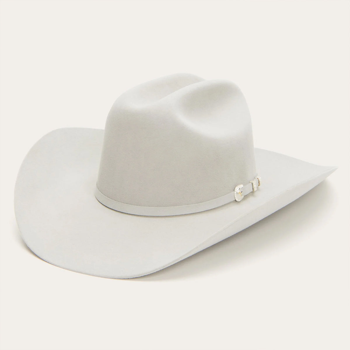 Stetson 10x Shasta mist grey felty cowboy hat with a decorative band on a white background.